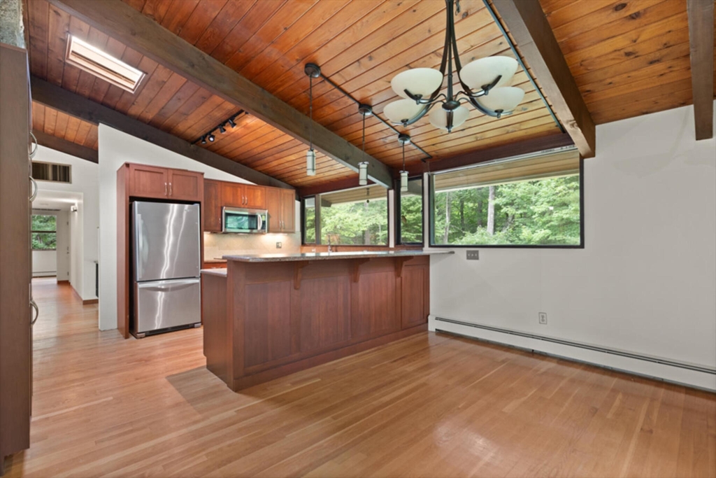 15 Pilgrims Path Sudbury, MA 01776 - Photo 8 of 29 a view of a kitchen with a sink window and stainless steel appliances
