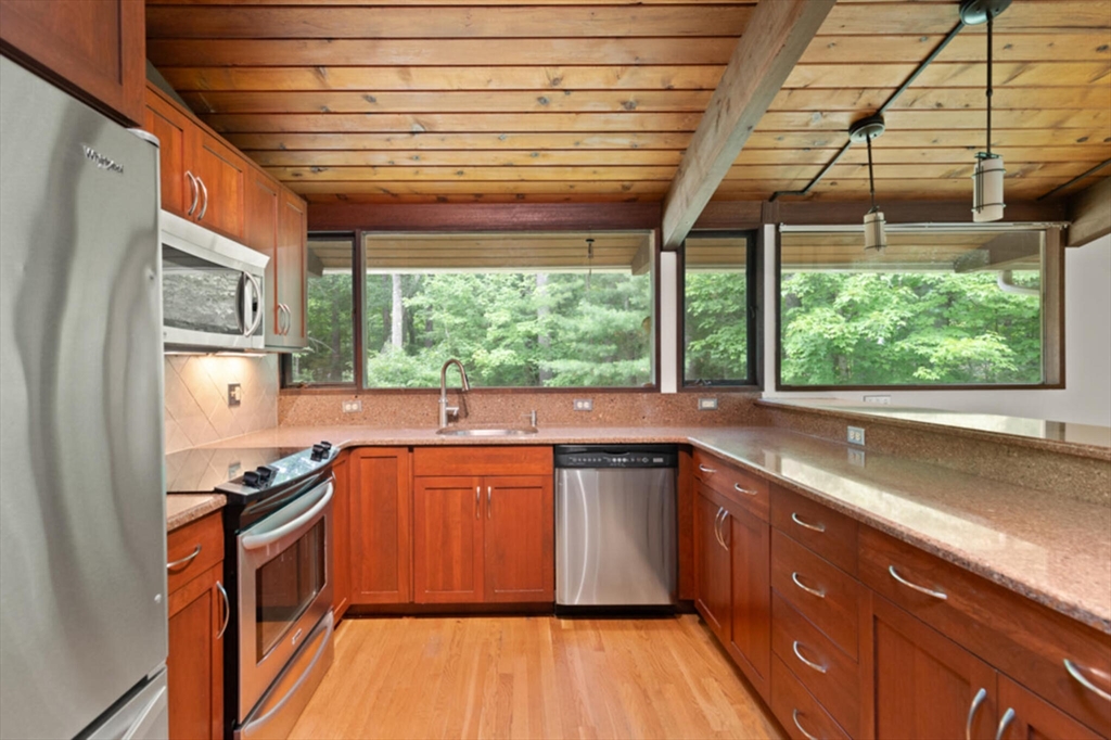 15 Pilgrims Path Sudbury, MA 01776 - Photo 9 of 29 a kitchen with stainless steel appliances granite countertop a sink stove and cabinets
