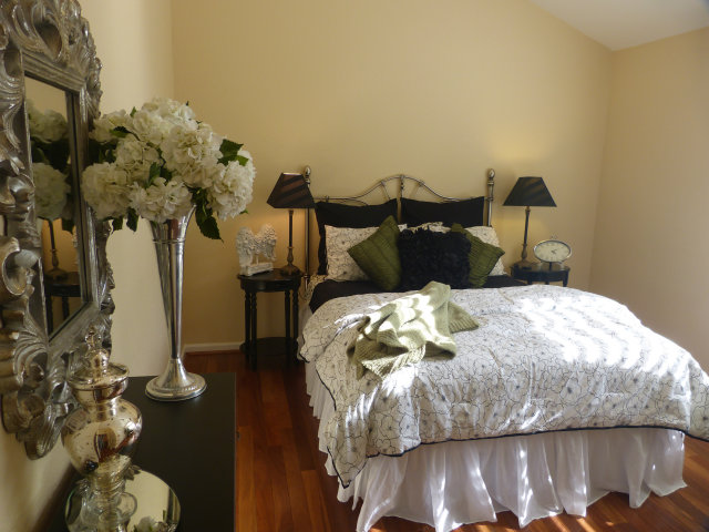 686 Regas Drive Campbell, CA 95008 - Photo 2 of 8 a bed sitting in a bedroom next to a window with potted plants