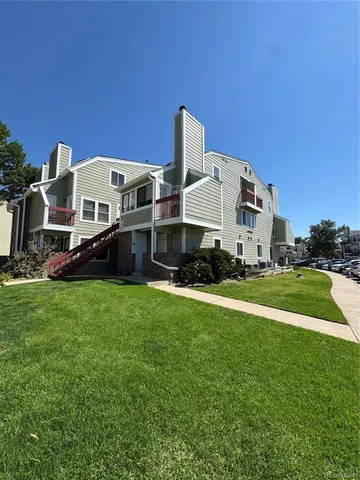 a front view of house with yard and car parked