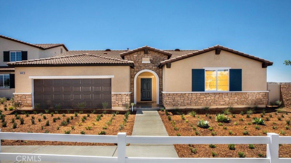 14064 Versimo Lane Beaumont, CA 92223 - Photo 1 of 1 a front view of a house with lots of yellow lighting
