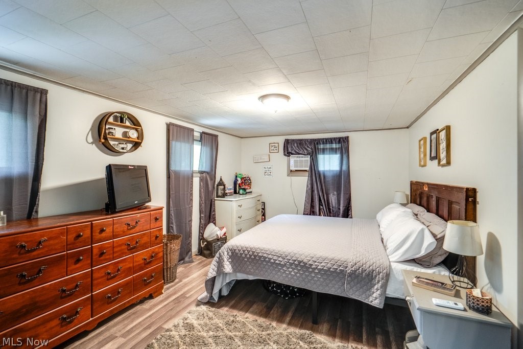 4219 Lake Rockwell Road Ravenna, OH 44266 - Photo 23 of 32 Bedroom with light hardwood / wood-style floors and a wall mounted air conditioner