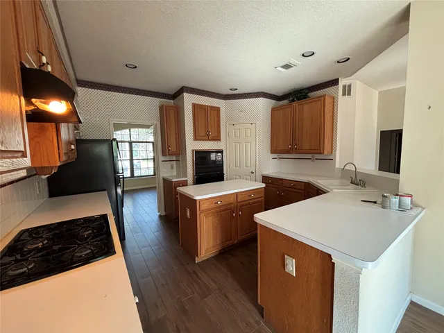 a kitchen with a sink stove and cabinets