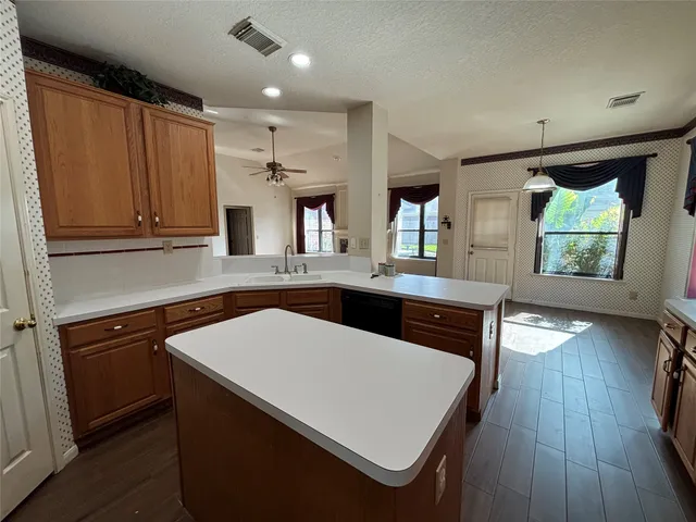 a kitchen with stainless steel appliances a stove a sink and a refrigerator