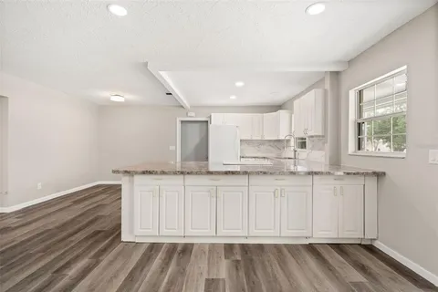 a kitchen with stainless steel appliances granite countertop a refrigerator and a sink