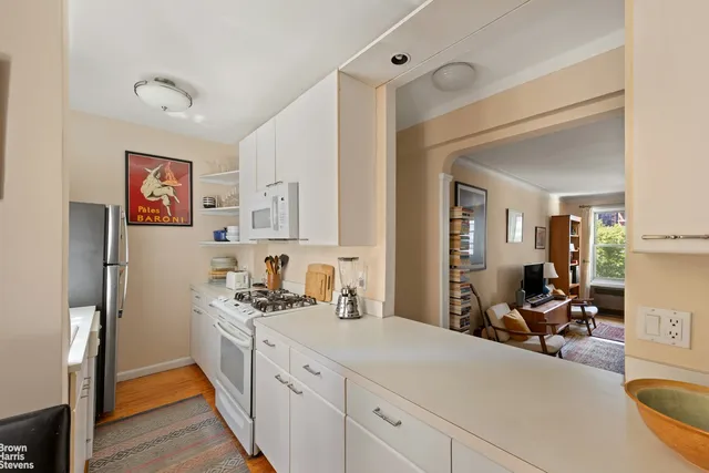 a hallway with furniture and a window