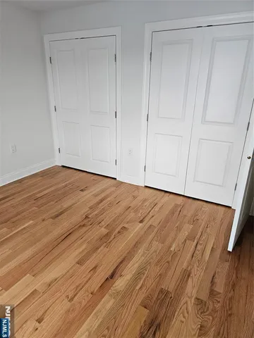 a view of room with wooden floor