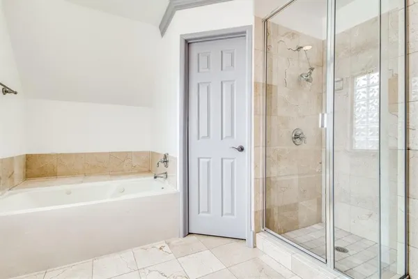 a bathroom with a bathtub and a shower