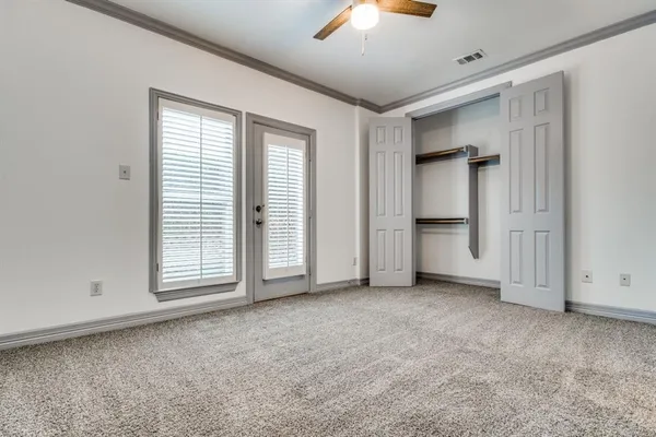 an empty room with windows and closet