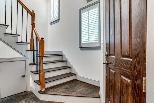 a view of entryway and hall with wooden floor