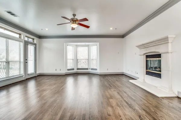 a view of a livingroom with wooden floor and window
