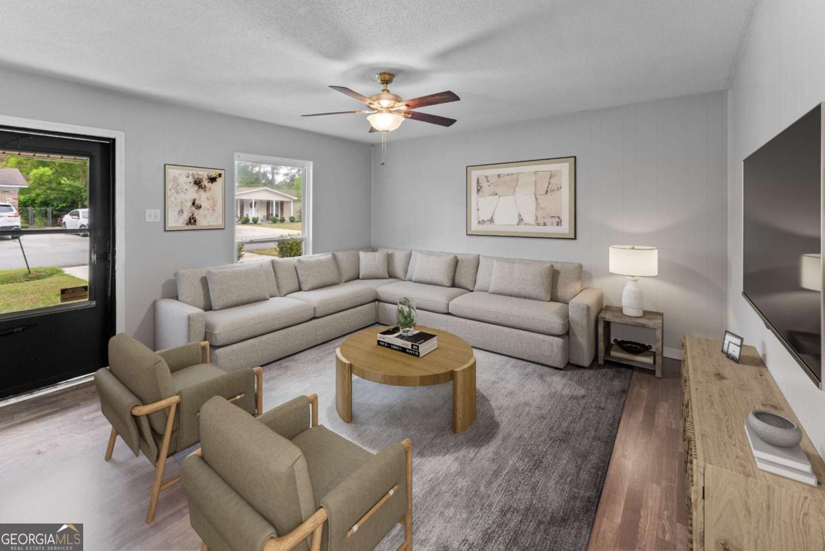 320 West Whatley Street Pooler, GA 31322 - Photo 8 of 34 a living room with furniture a chandelier and a window