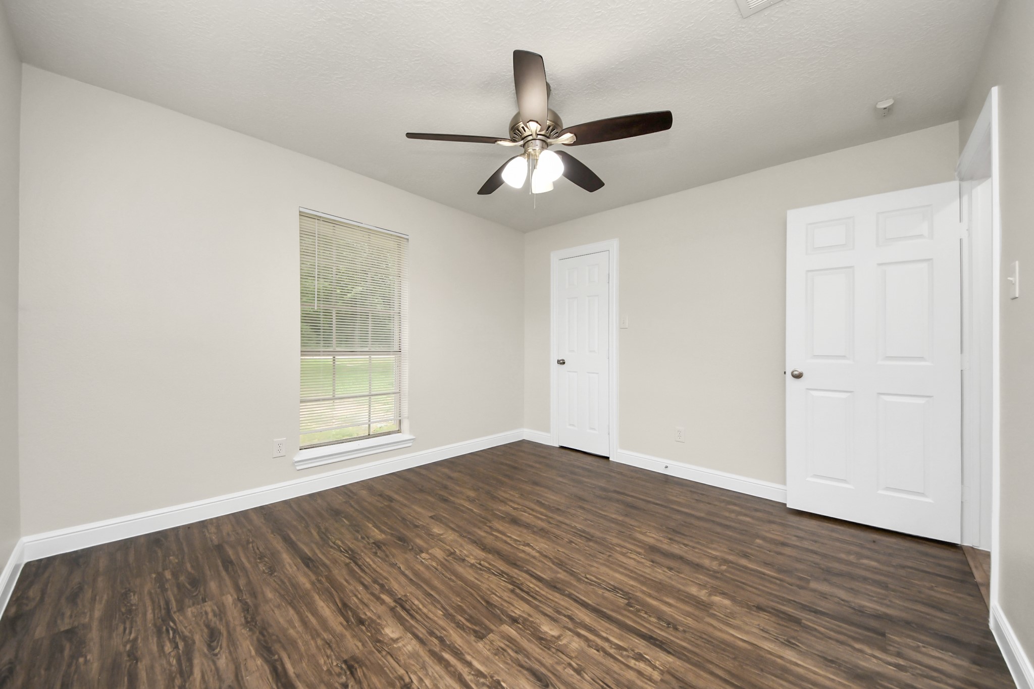 19435 Interstate 45 Spring, TX 77388 - Photo 23 of 24 an empty room with wooden floor ceiling fan and windows