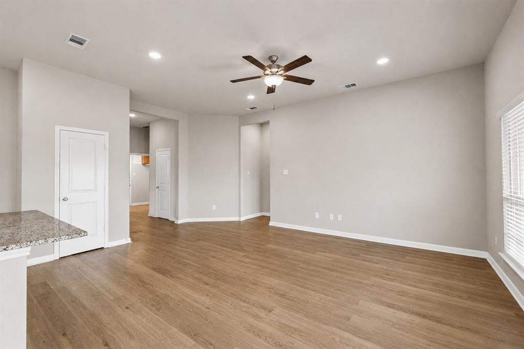 3213 Dottavio Road Lorena, TX 76655 - Photo 4 of 32 a view of an empty room with wooden floor and a ceiling fan