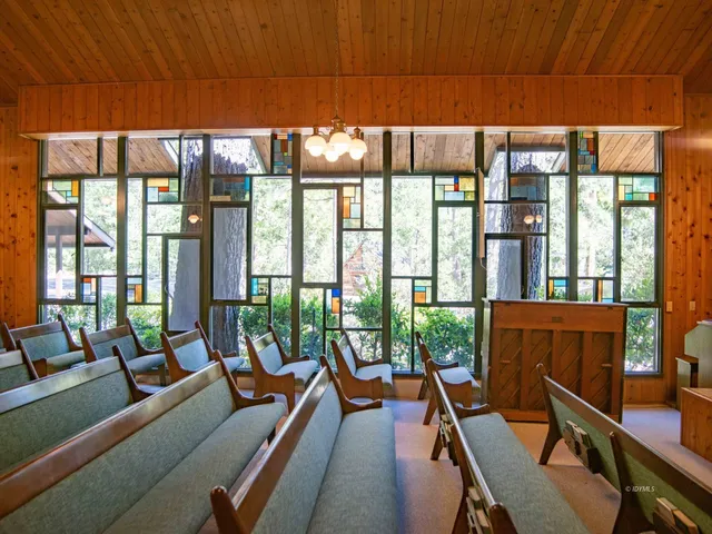 a living room with furniture and a floor to ceiling window