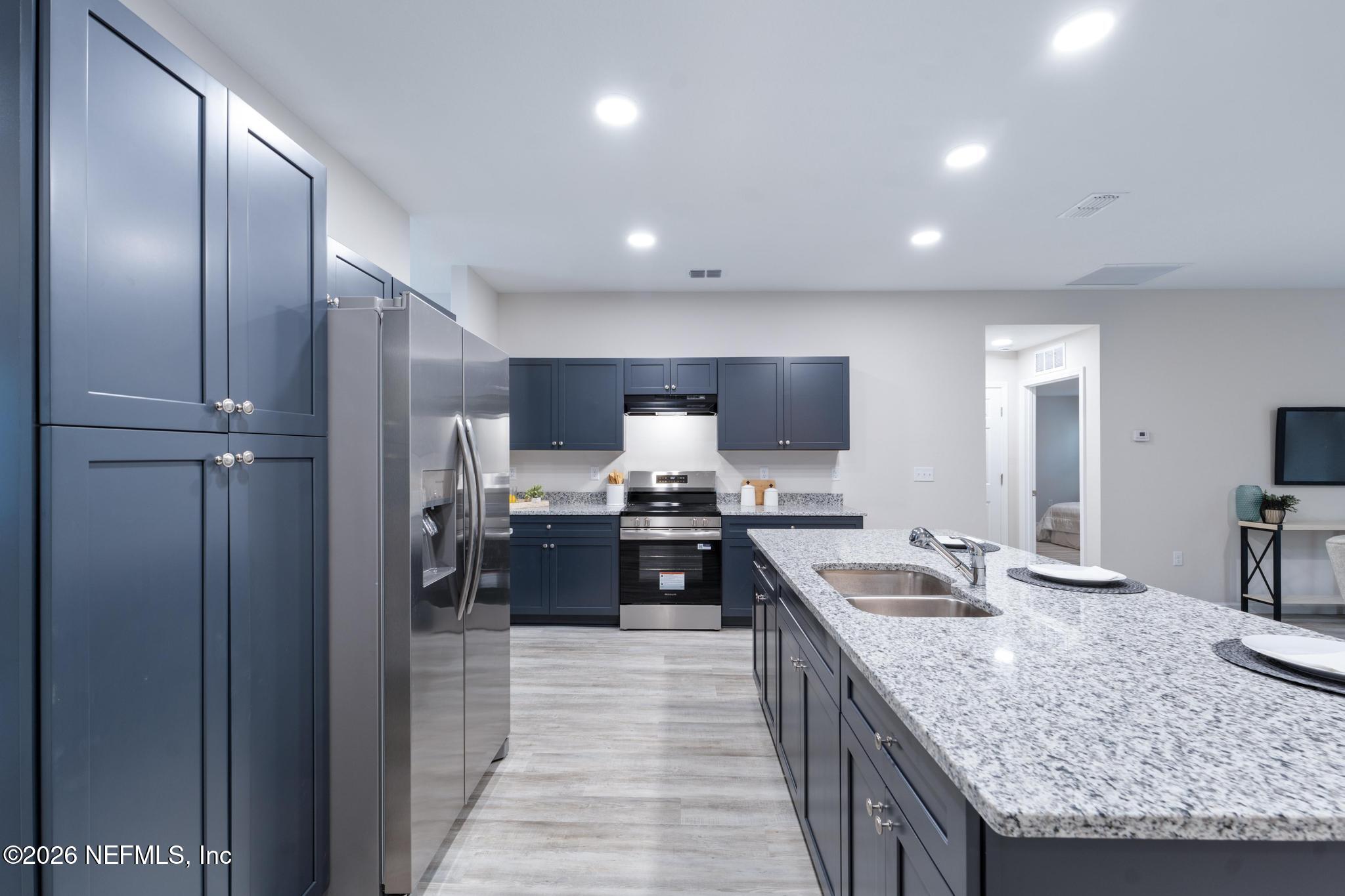 7581 Dove Road Jacksonville, FL 32219 - Photo 11 of 32 a large kitchen with kitchen island a large counter top