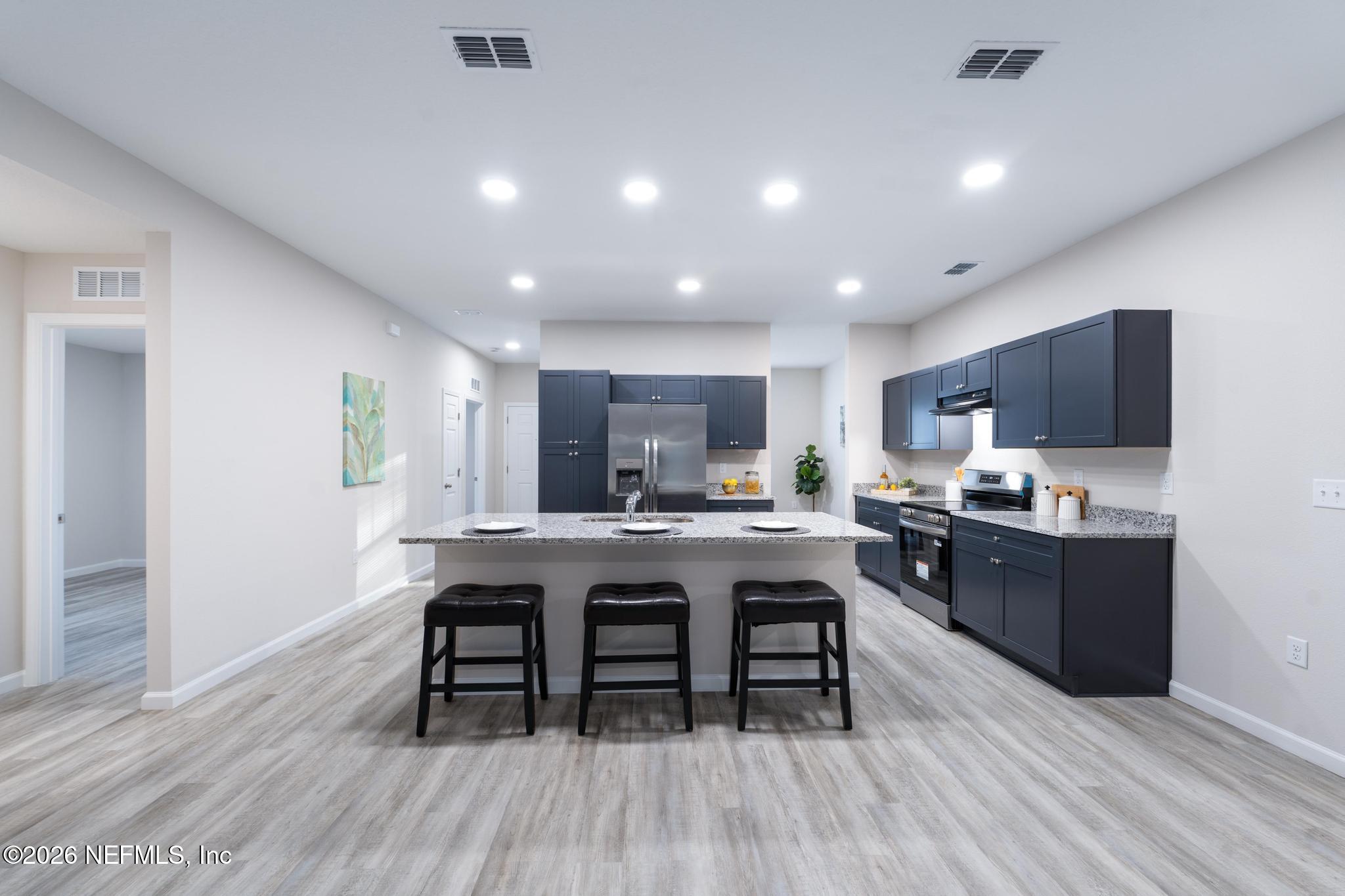 7581 Dove Road Jacksonville, FL 32219 - Photo 14 of 32 a kitchen with a table and chairs in it
