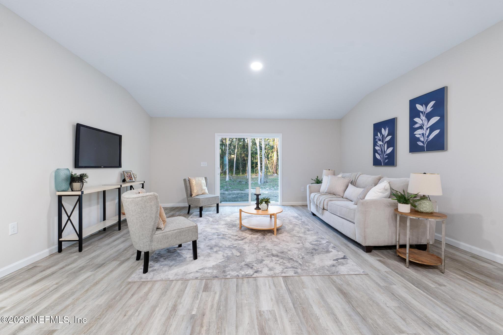 7581 Dove Road Jacksonville, FL 32219 - Photo 16 of 32 a living room with furniture and a wooden floor