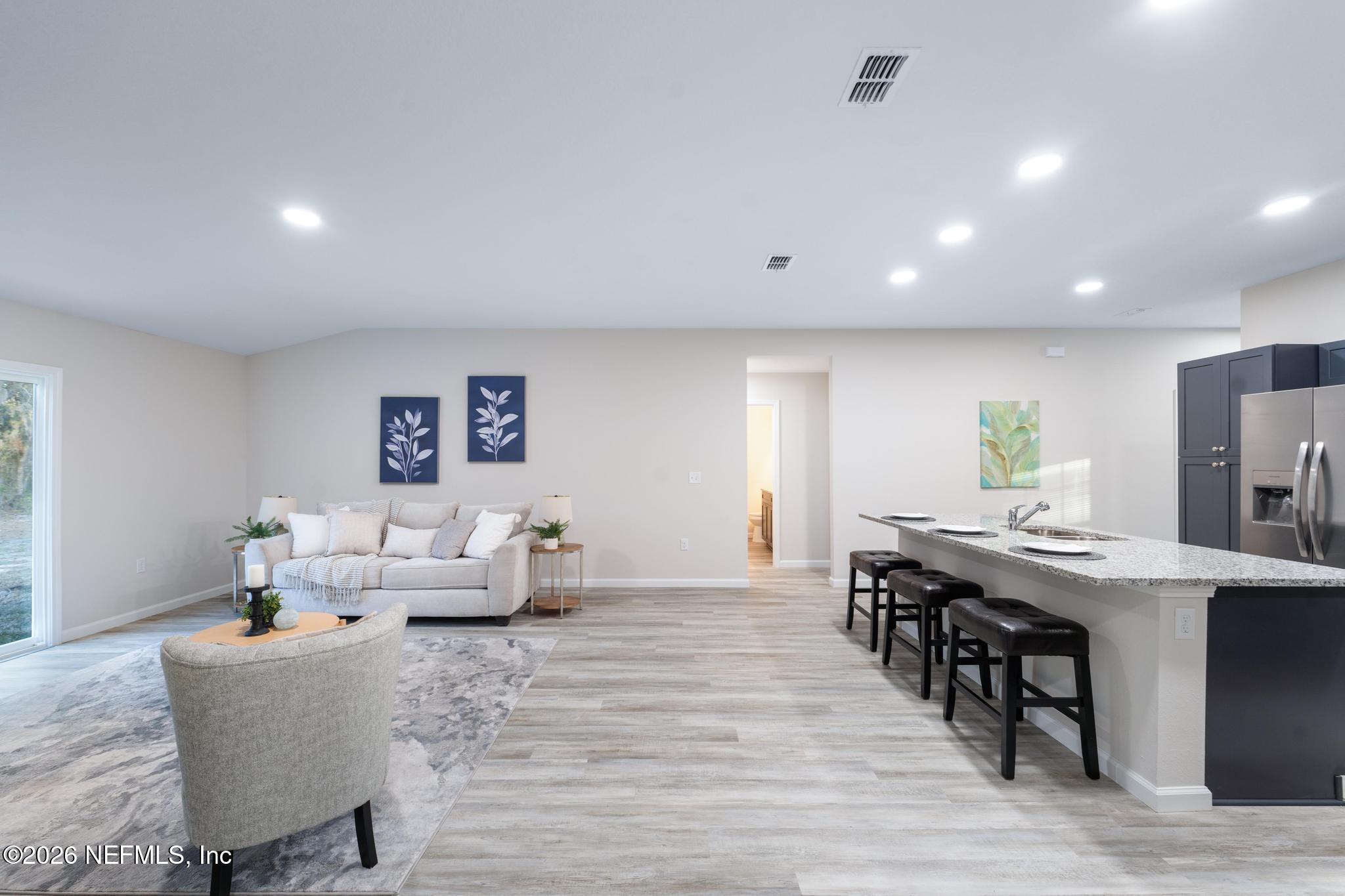 7581 Dove Road Jacksonville, FL 32219 - Photo 18 of 32 a living room with furniture and wooden floor
