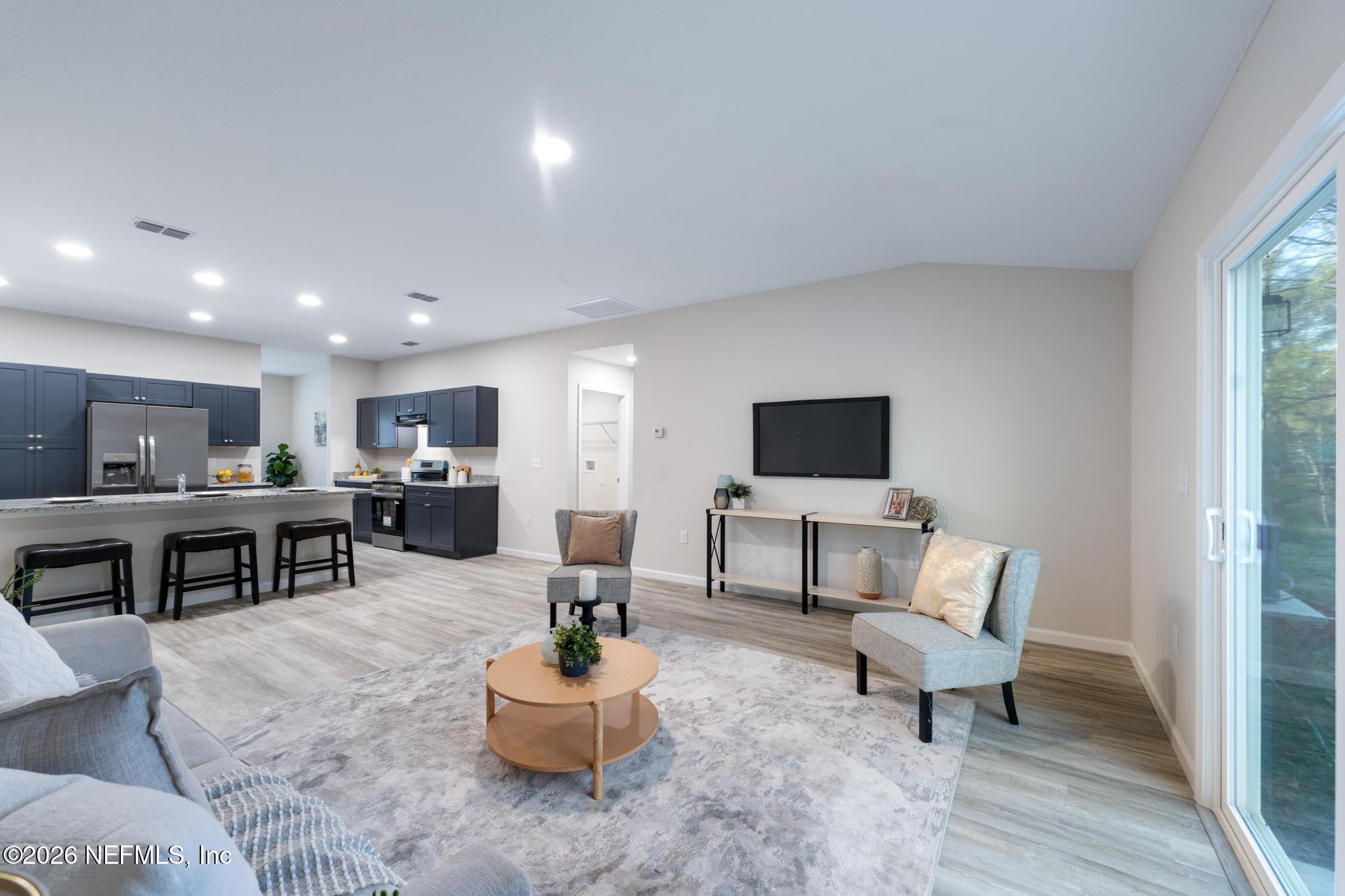 7581 Dove Road Jacksonville, FL 32219 - Photo 20 of 32 a living room with furniture and a flat screen tv