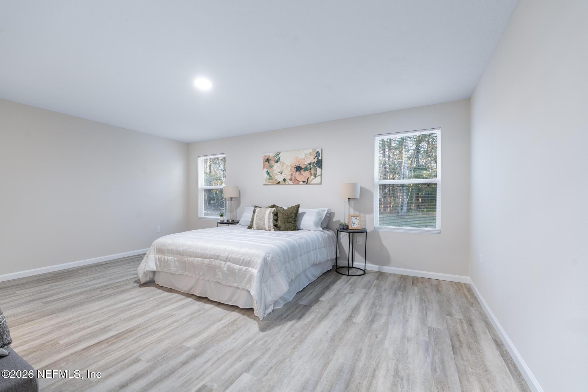 7581 Dove Road Jacksonville, FL 32219 - Photo 21 of 32 a spacious bedroom with a bed and a window