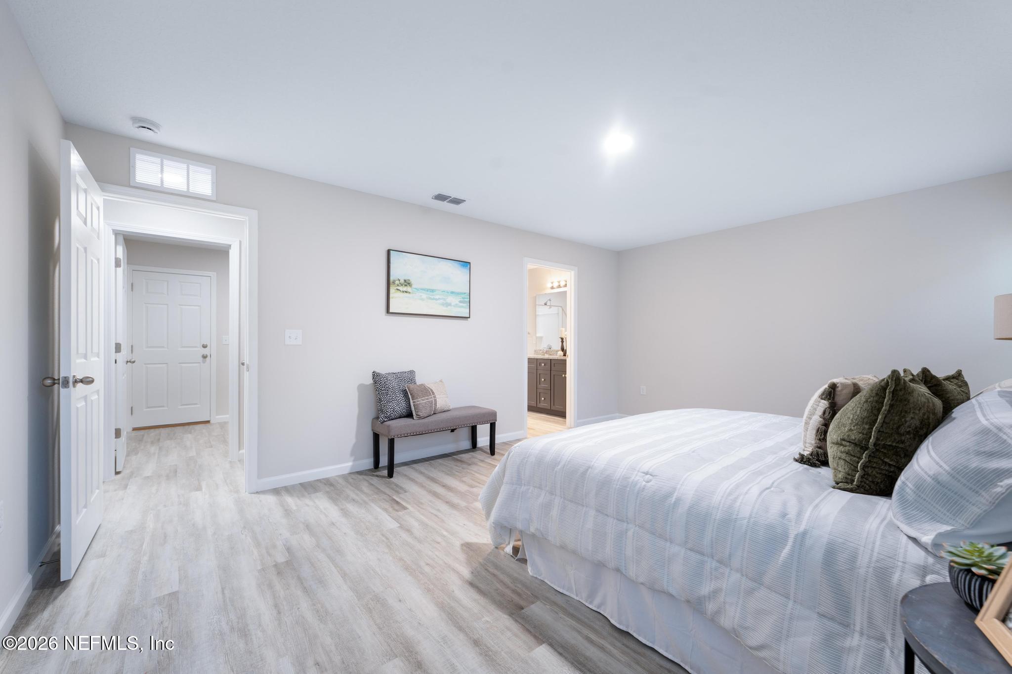 7581 Dove Road Jacksonville, FL 32219 - Photo 22 of 32 a bedroom with a bed and wooden floor