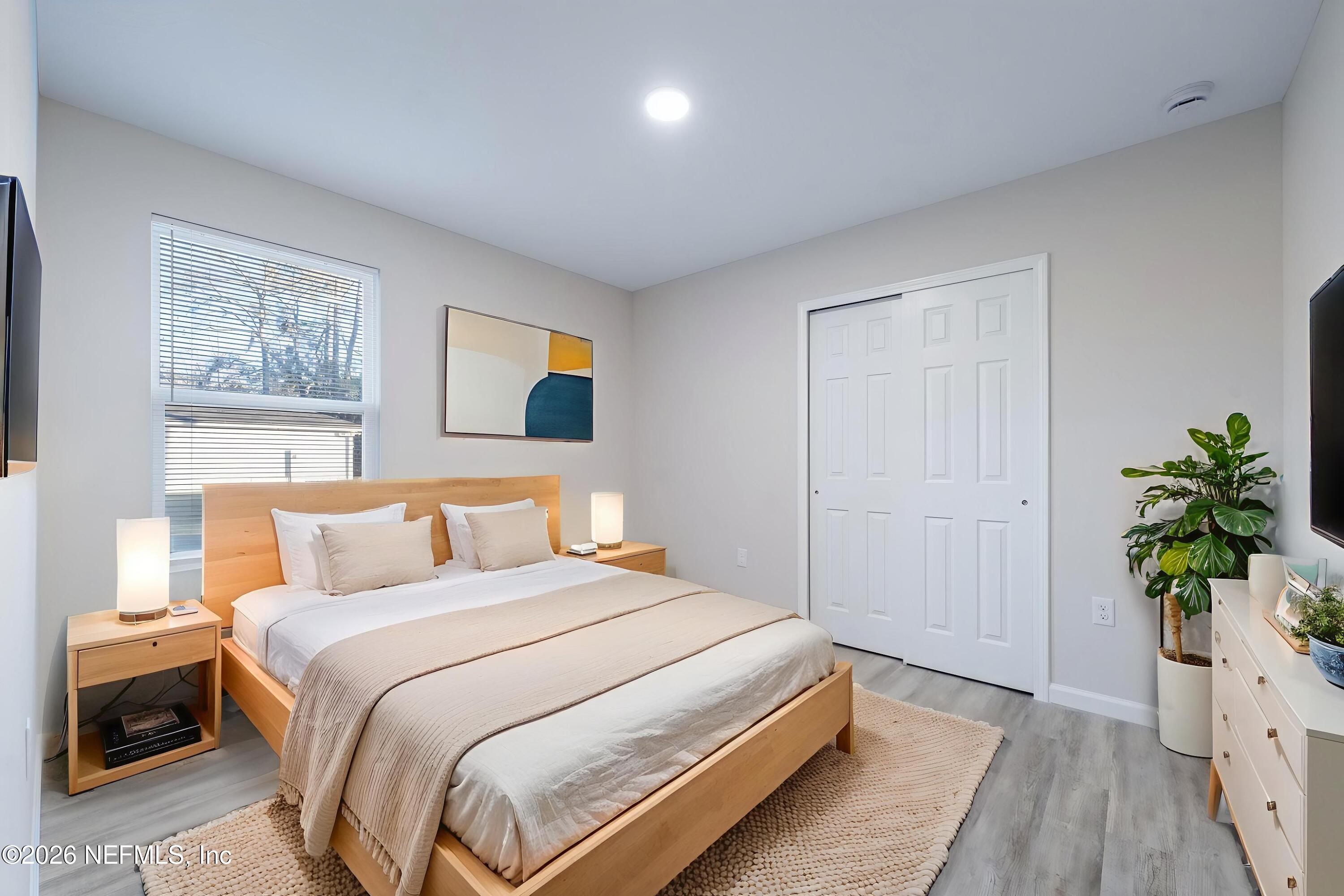 7581 Dove Road Jacksonville, FL 32219 - Photo 25 of 32 a bedroom with a bed and a potted plant