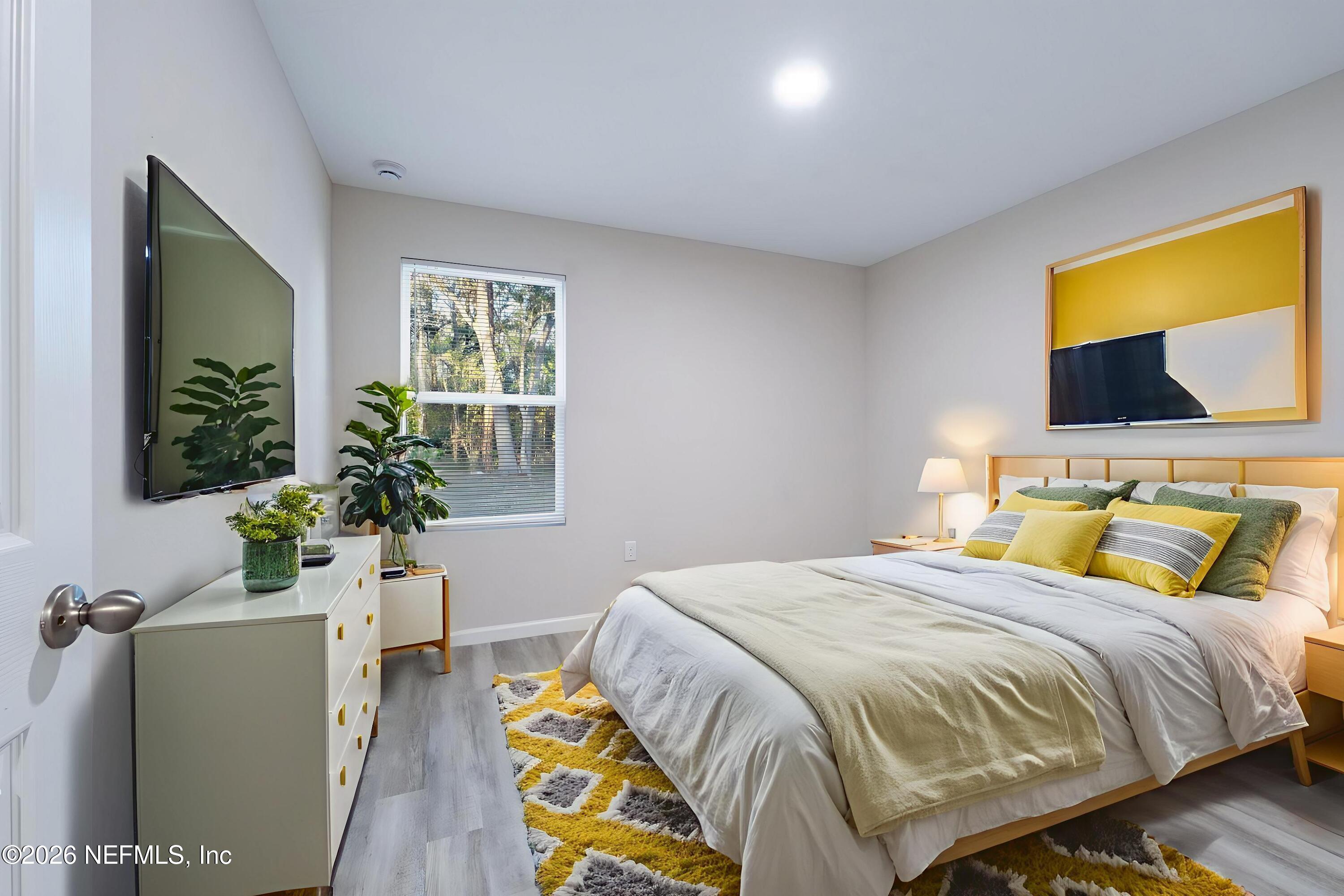 7581 Dove Road Jacksonville, FL 32219 - Photo 28 of 32 a bedroom with a bed and flat screen tv