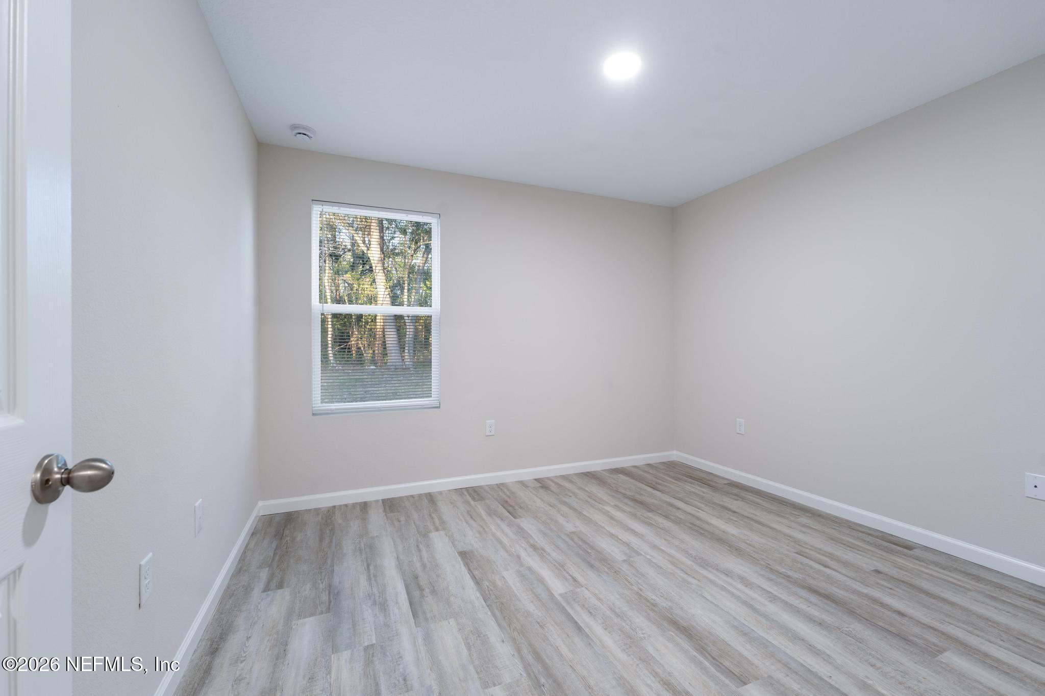 7581 Dove Road Jacksonville, FL 32219 - Photo 29 of 32 wooden floor in an empty room with a window
