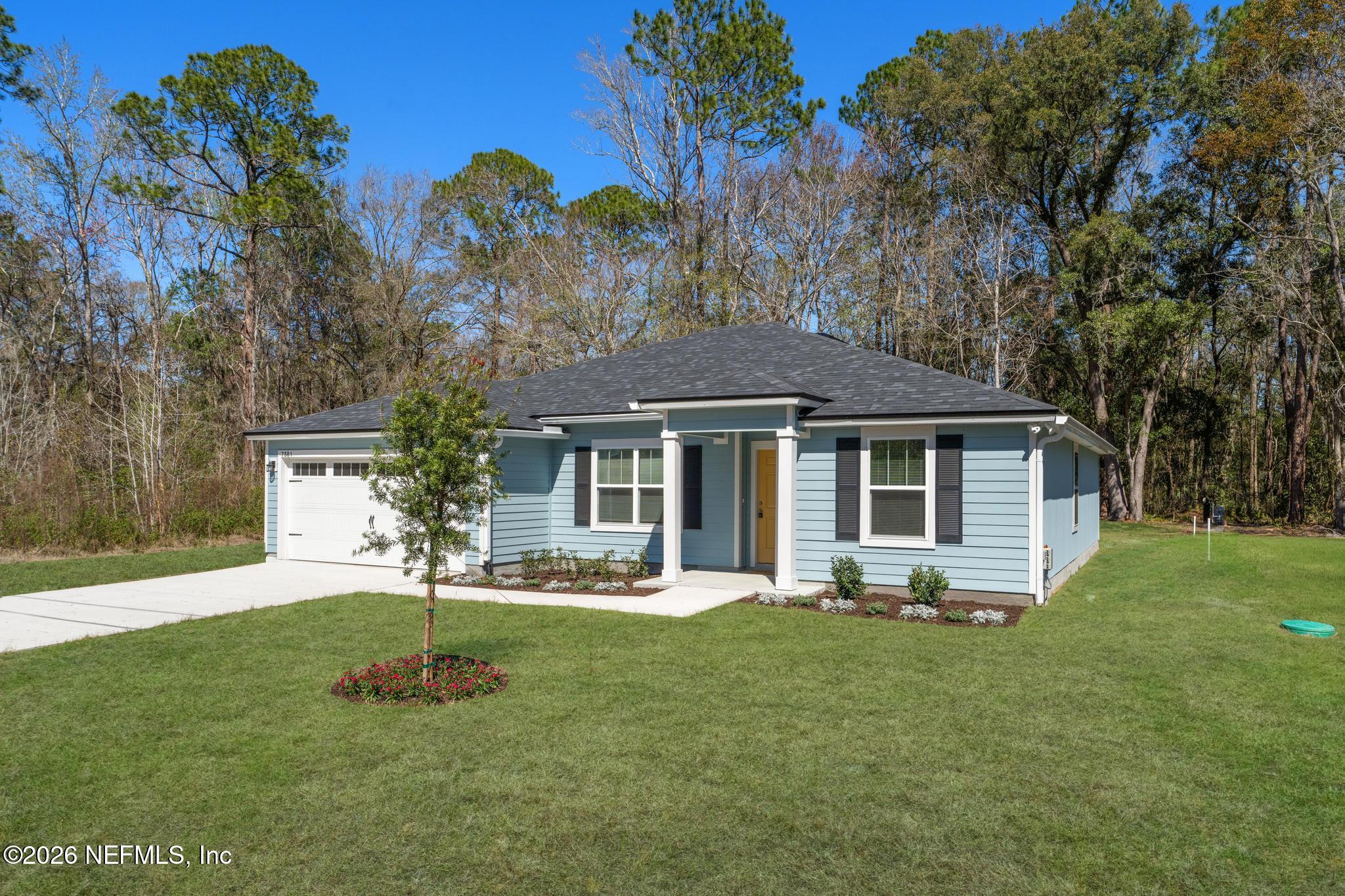 7581 Dove Road Jacksonville, FL 32219 - Photo 3 of 32 a front view of a house with a yard garden and outdoor seating