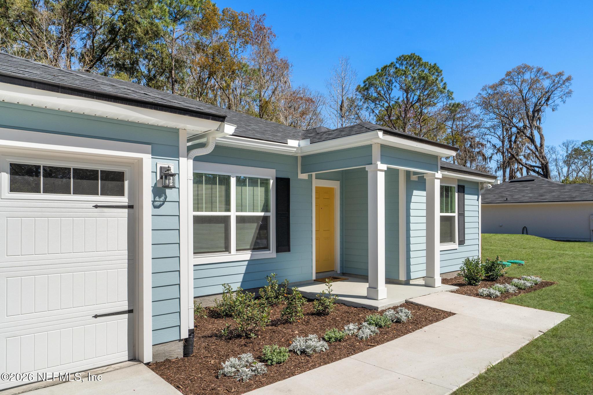 7581 Dove Road Jacksonville, FL 32219 - Photo 4 of 32 a front view of a house with garden