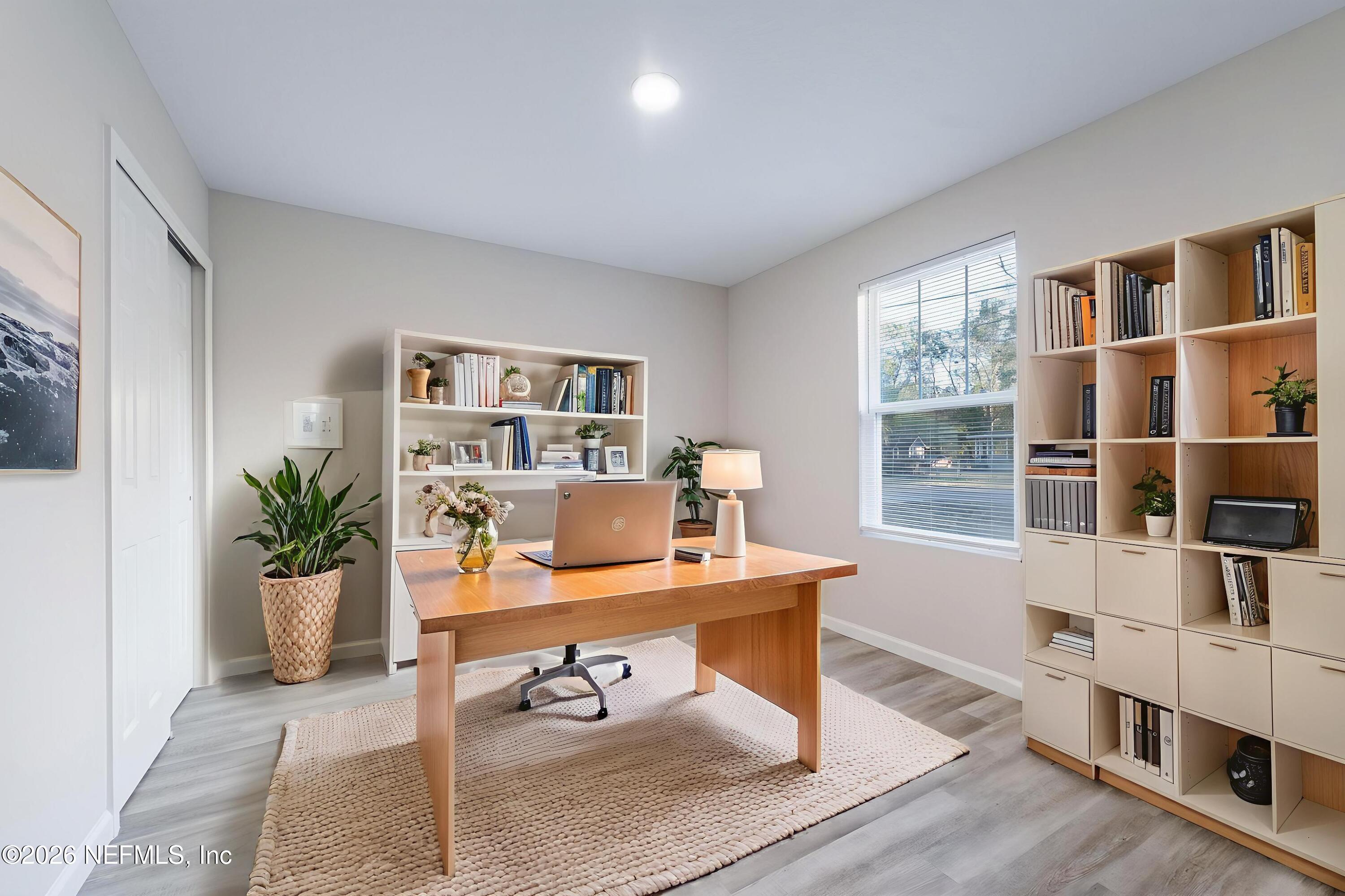 7581 Dove Road Jacksonville, FL 32219 - Photo 6 of 32 a workspace with furniture and book shelf