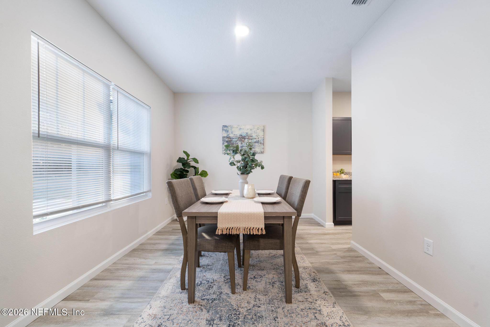 7581 Dove Road Jacksonville, FL 32219 - Photo 8 of 32 a view of a dining room with furniture and window