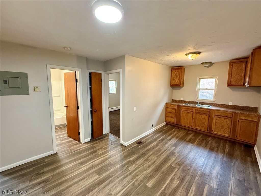 4652 Warner Road, Unit 3 Cleveland, OH 44125 - Photo 9 of 13 Kitchen with wood finish cabinetry, electric panel, dark wood-type flooring, and plenty of natural light