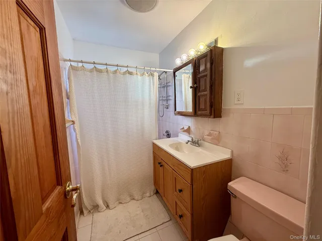 a bathroom with a sink toilet vanity and shower