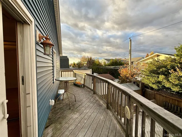 a view of a balcony with wooden floor and fence