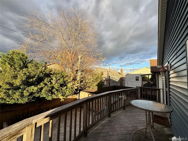 a view of a balcony with wooden chairs and floor