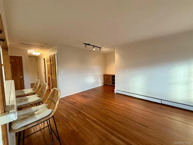 a view of a room with wooden floor