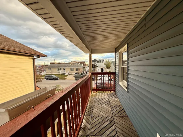 a view of a balcony with wooden floor