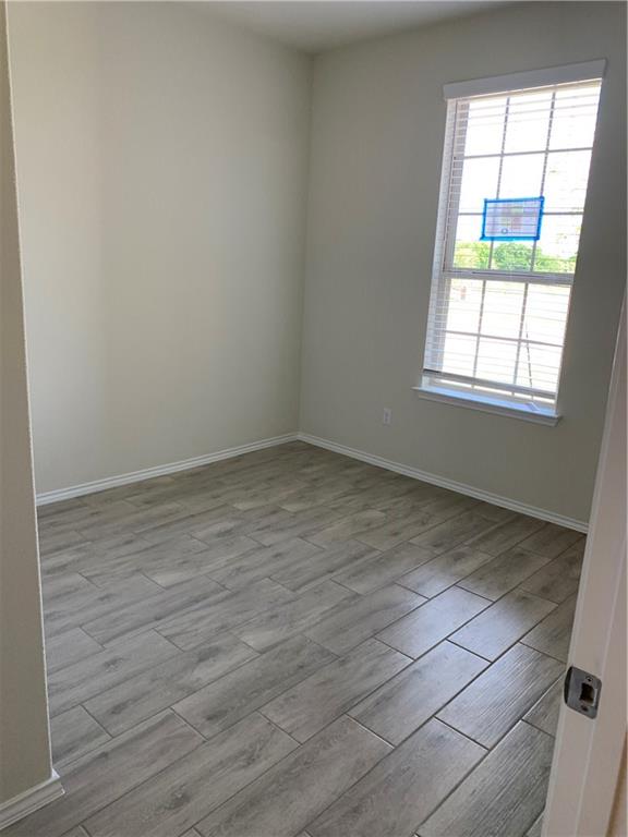 1229 Cliffbrake Way Georgetown, TX 78626 - Photo 17 of 24 an empty room with wooden floor and windows