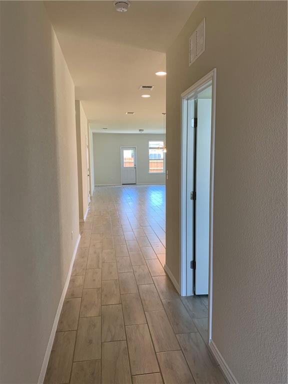 1229 Cliffbrake Way Georgetown, TX 78626 - Photo 4 of 24 a view of a hallway with wooden floor