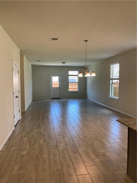 1229 Cliffbrake Way Georgetown, TX 78626 - Photo 7 of 24 a view of a room with window wooden floor and windows