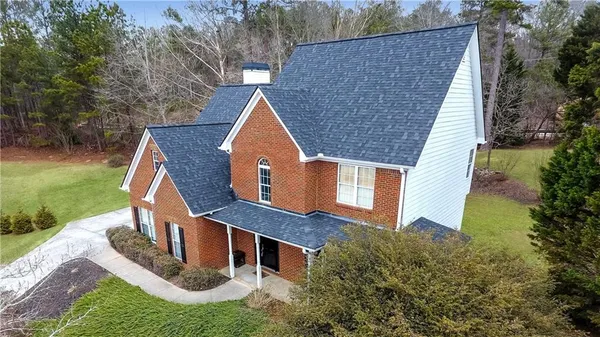 a aerial view of a house with a yard