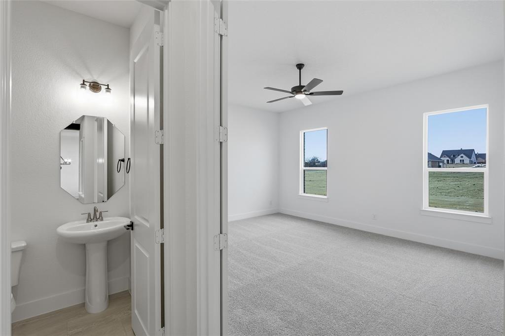 810 Vly Rdg Road Van Alstyne, TX 75495 - Photo 17 of 39 Half bath with toilet and ceiling fan