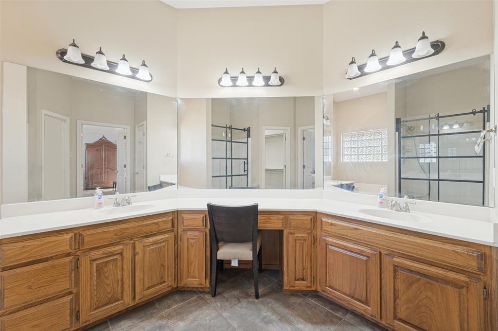 1601 East Blackjack Road East Pilot Point, TX 76258 - Photo 9 of 30 Dual vanity with white countertops, wood-finish cabinetry, and integrated sinks