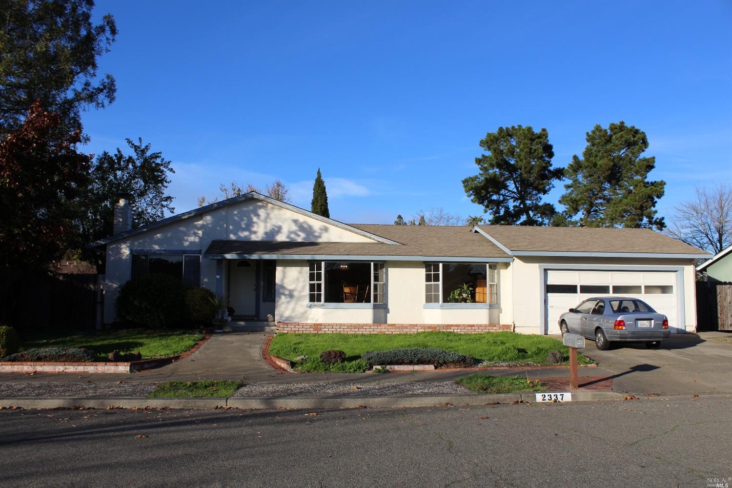 2337 Floral Way Santa Rosa, CA 95403 - Photo 1 of 1 a front view of a house with a yard and garage