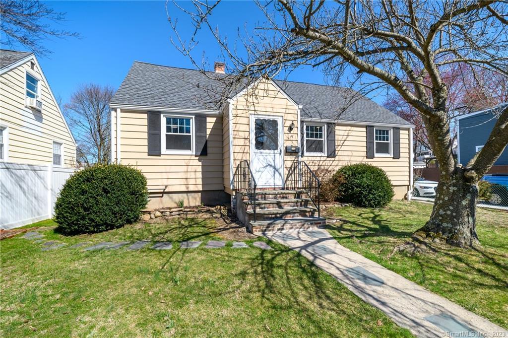 a front view of house with yard outdoor seating and barbeque oven