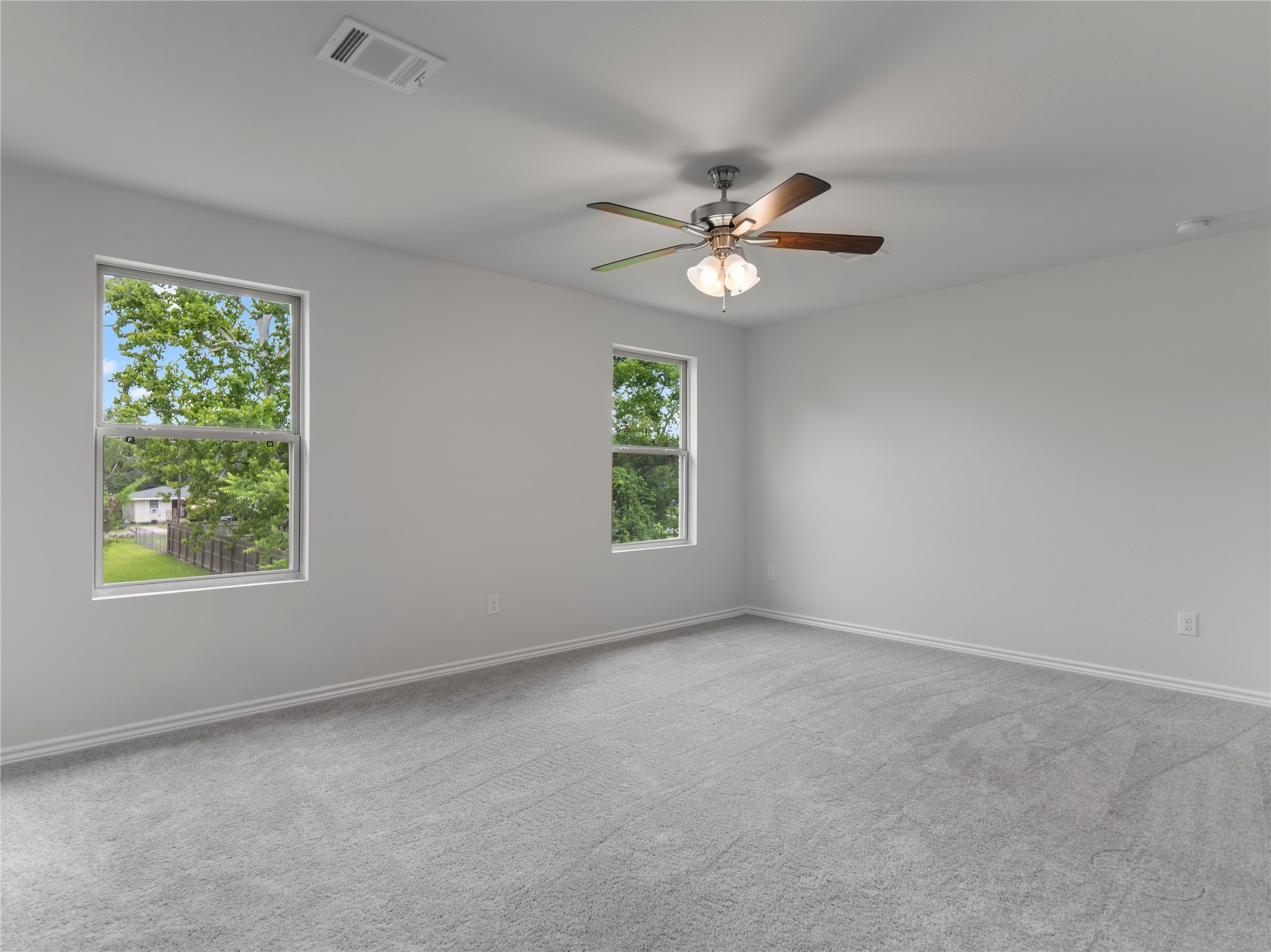 306 North Orange Street Sweeny, TX 77480 - Photo 16 of 30 Spacious upstairs bedroom with plush carpet and natural light.
