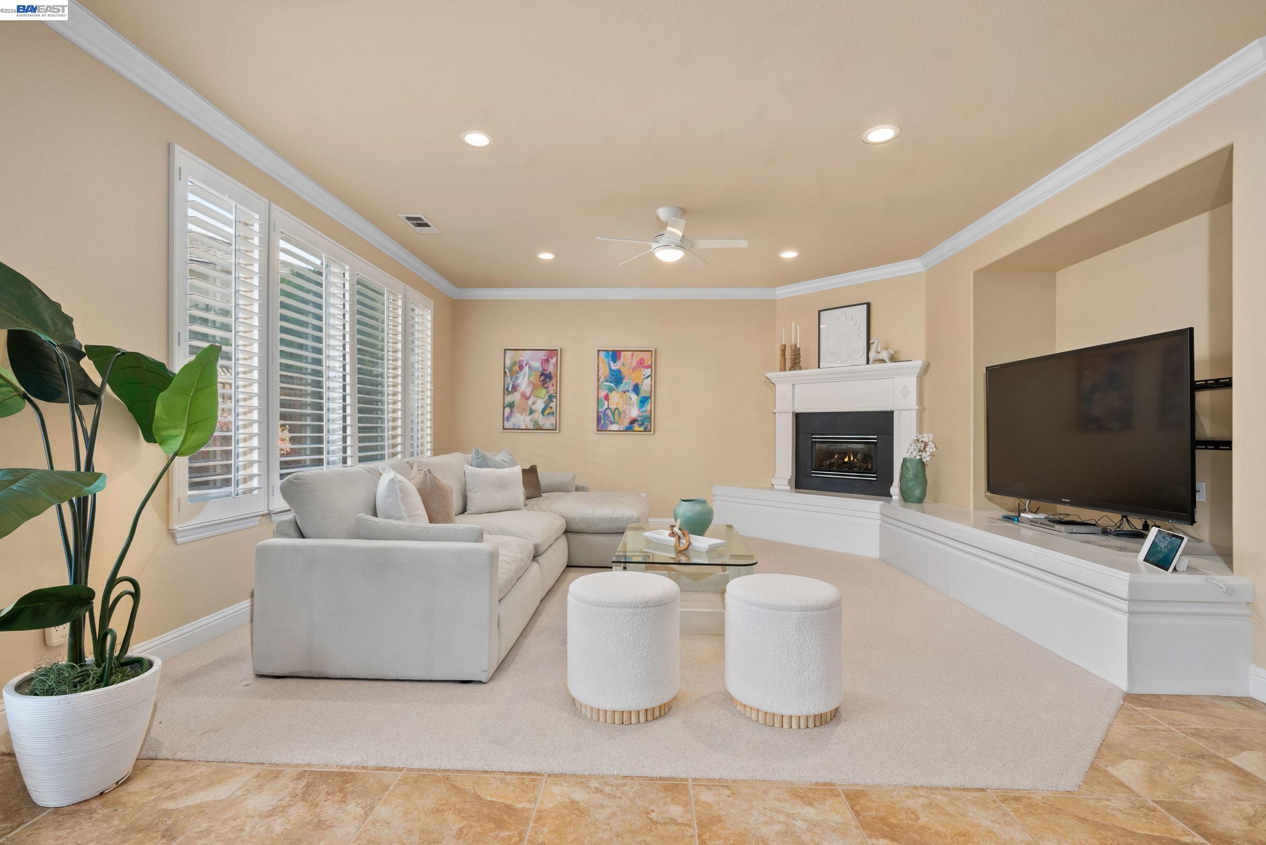4717 Chestnut Court Dublin, CA 94568 - Photo 12 of 60 a living room with furniture a flat screen tv and a fireplace