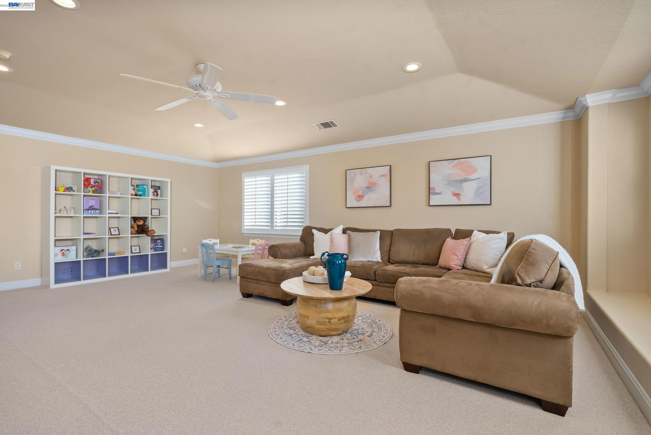 4717 Chestnut Court Dublin, CA 94568 - Photo 26 of 60 a living room with furniture a rug and a book shelf